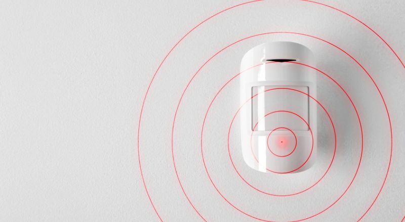 detecteur de mouvement a infrarouge sur un mur interieur blanc