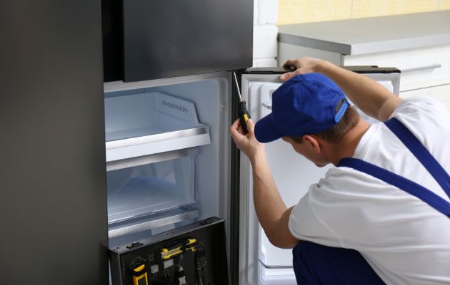 un-ouvrier-réparant-un frigo